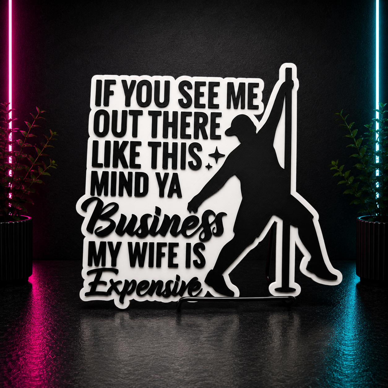 Black and white 3D printed funny pole dancing sign that reads "If You See Me Out There Like This Mind Ya Business My Wife Is Expensive" with raised lettering and silhouette artwork.