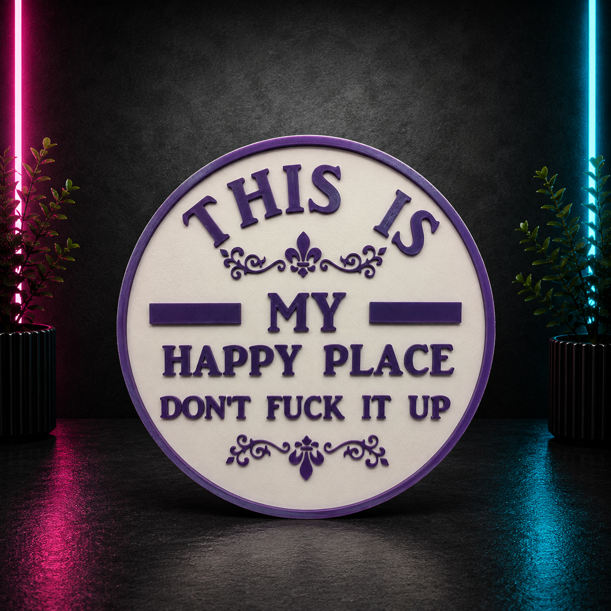 Round decorative plaque with the phrase "This Is My Happy Place Don't F*** It Up" in purple lettering on a white background.