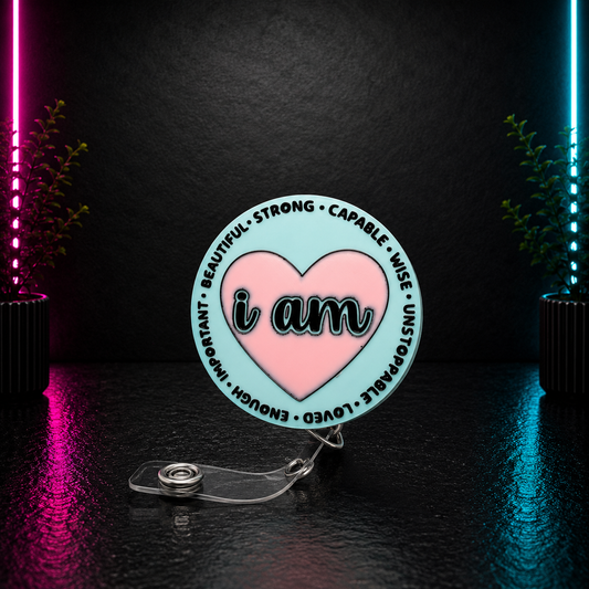Inspirational "I Am" retractable badge reel featuring a pink heart with positive affirmations including Beautiful, Strong, Capable, Wise, Loved, Enough, and Unstoppable.