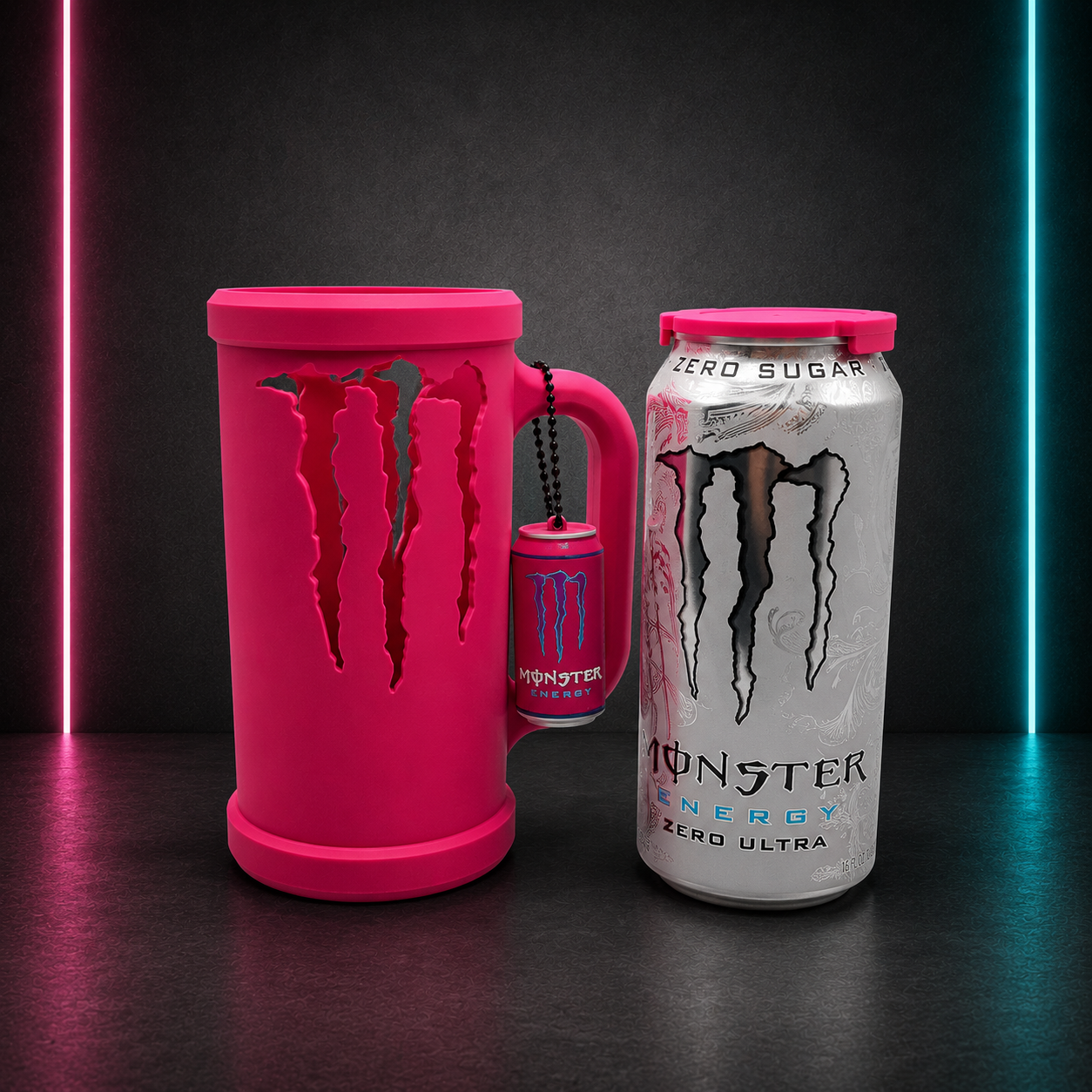 Hot pink Monster inspired slim energy drink holder with matching mini can keychain displayed on neon background for gaming desk and office setup